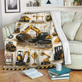 Excavator throw blanket draped over a sofa with construction vehicle collage artwork