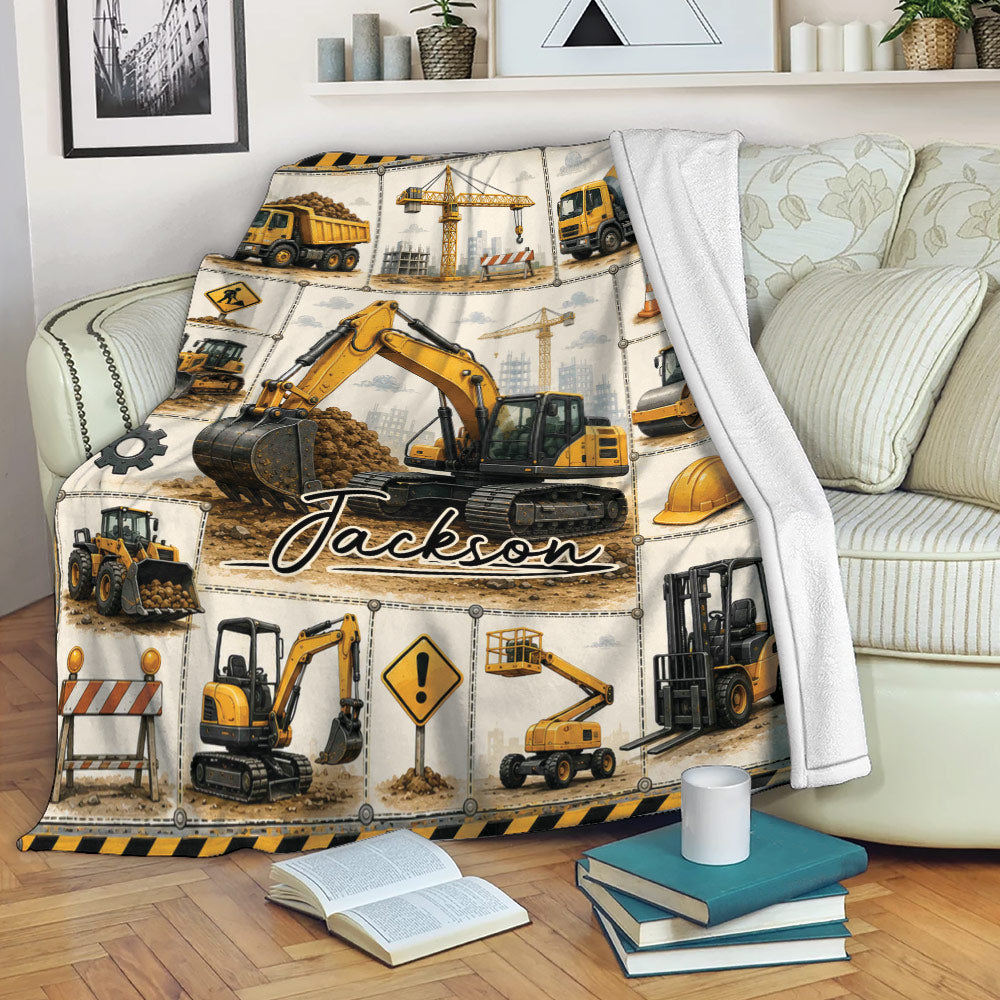 Excavator throw blanket draped over a sofa with construction vehicle collage artwork
