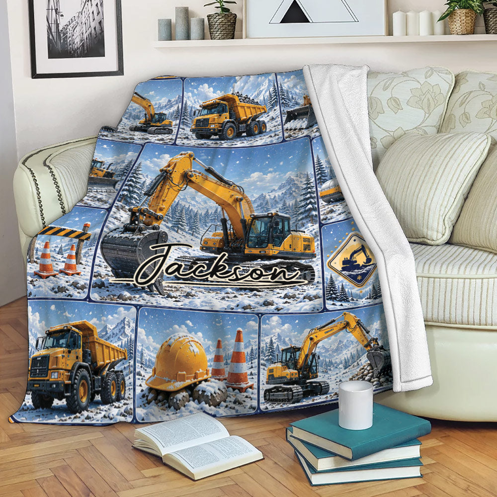 Excavator throw blanket draped over a sofa with snowy construction artwork
