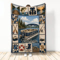Custom pontoon boat throw blanket displayed upright with lake, fishing, and boating artwork in navy and tan