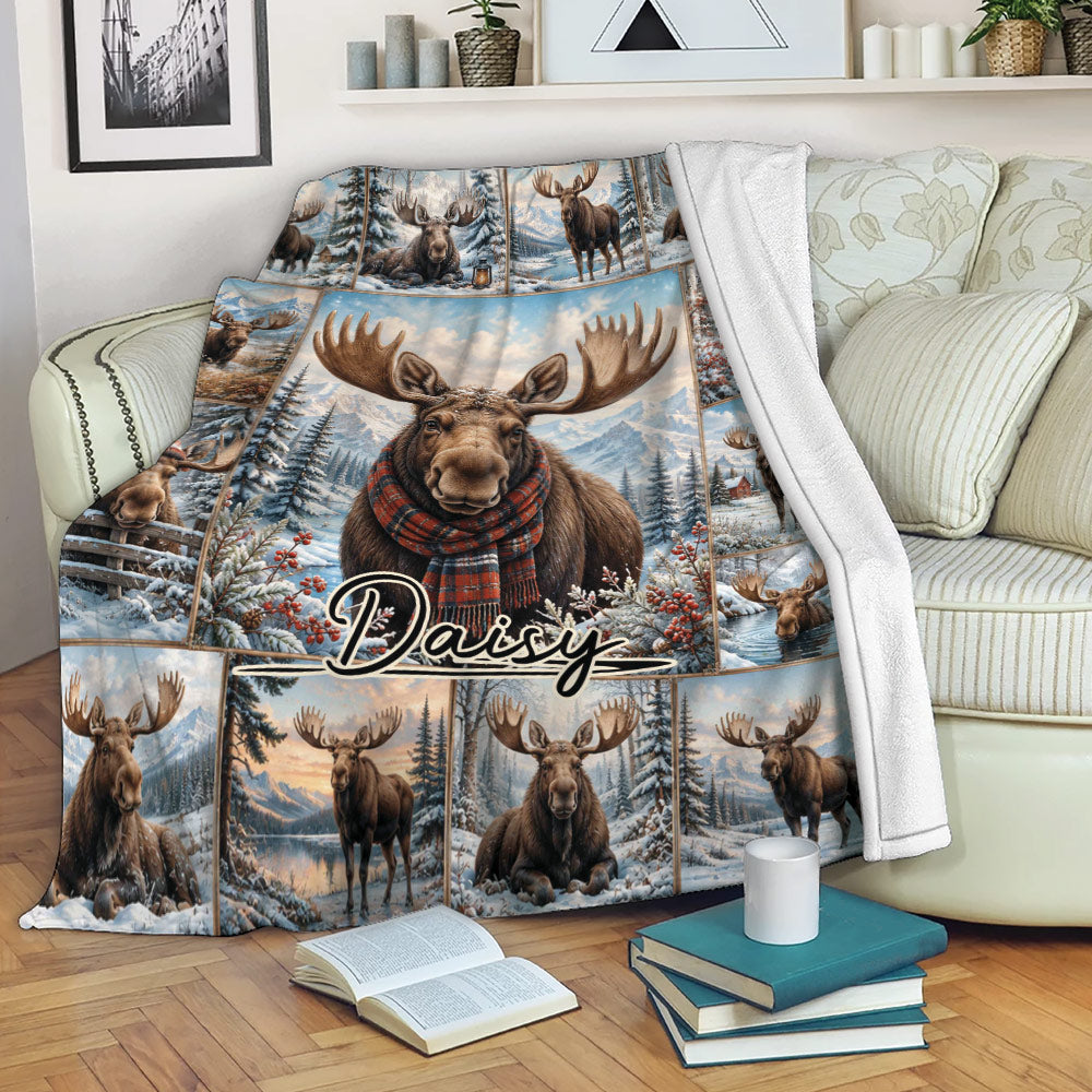 Moose blanket draped over a sofa, featuring a scarf-wearing moose in a snowy alpine forest collage