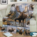Close view of a moose throw blanket on a sofa with alpine landscape and wildlife collage