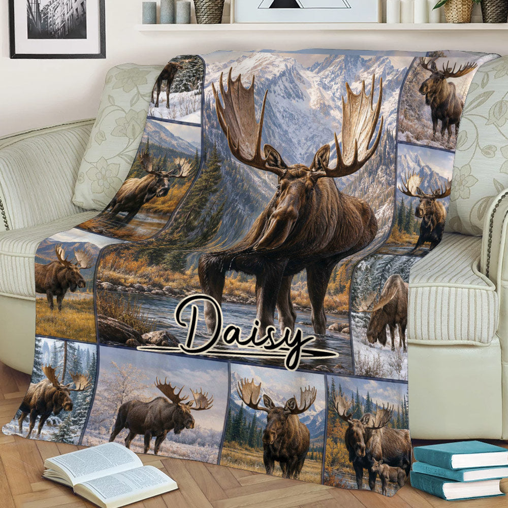 Close view of a moose throw blanket on a sofa with alpine landscape and wildlife collage