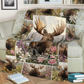 Moose wildlife blanket spread across a sofa, featuring flowers, mountains, and forest scenery