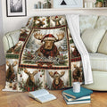 Custom Christmas moose blanket draped over a sofa with plaid wildlife panels and snowy holiday artwork