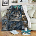 Wolf blanket draped over a sofa, showing a large wolf portrait surrounded by snowy forest and mountain scenes