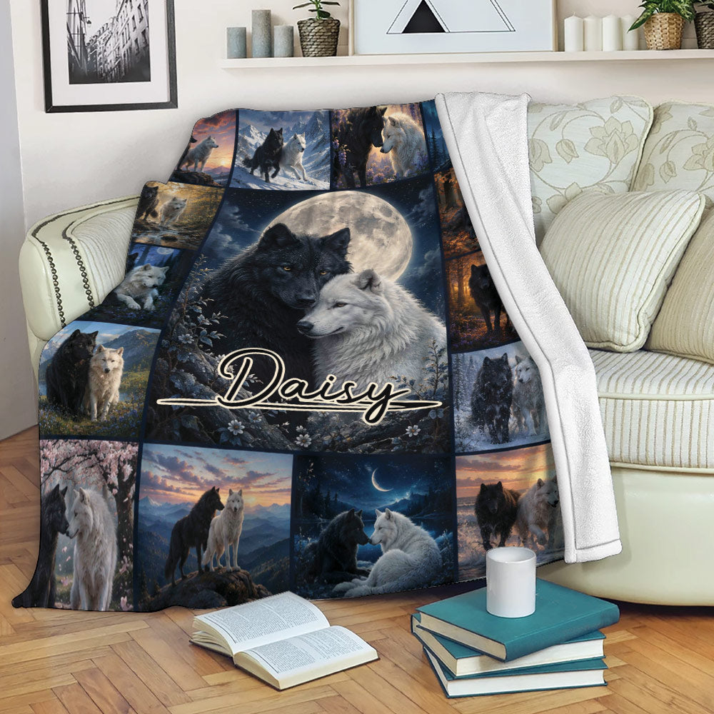 Wolf blanket draped over a sofa with black and white wolf artwork and scenic nature panels