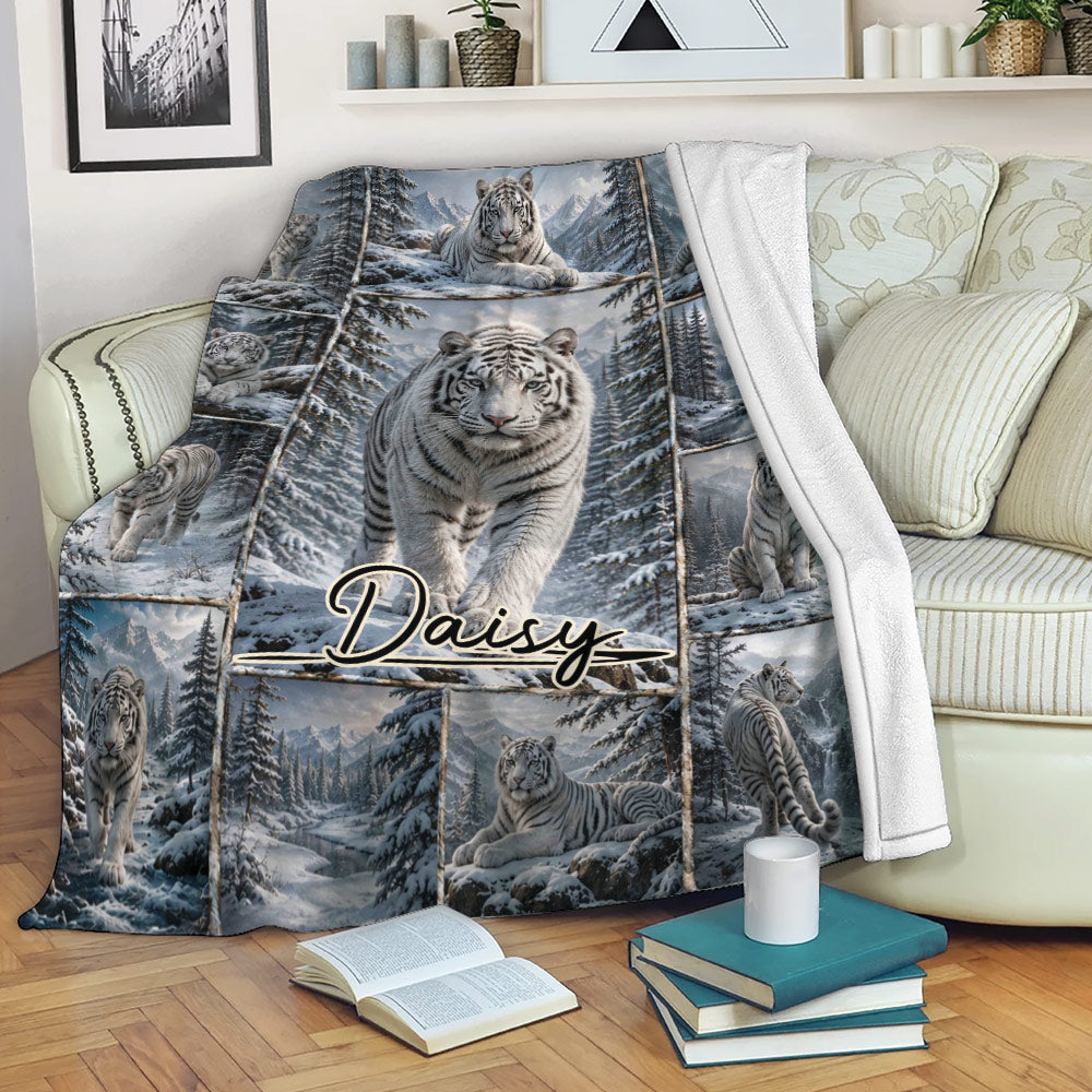 White tiger blanket draped over a sofa with snowy forest and mountain artwork