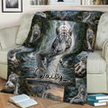 White tiger blanket displayed across a sofa with detailed forest and mountain artwork