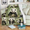 Panda blanket draped over a sofa, showing bamboo forest artwork and multiple pandas