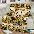 Sunflower panda blanket displayed across a sofa with playful panda scenes and botanical details