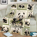 Panda throw blanket displayed on a sofa with playful panda illustrations and daisy accents