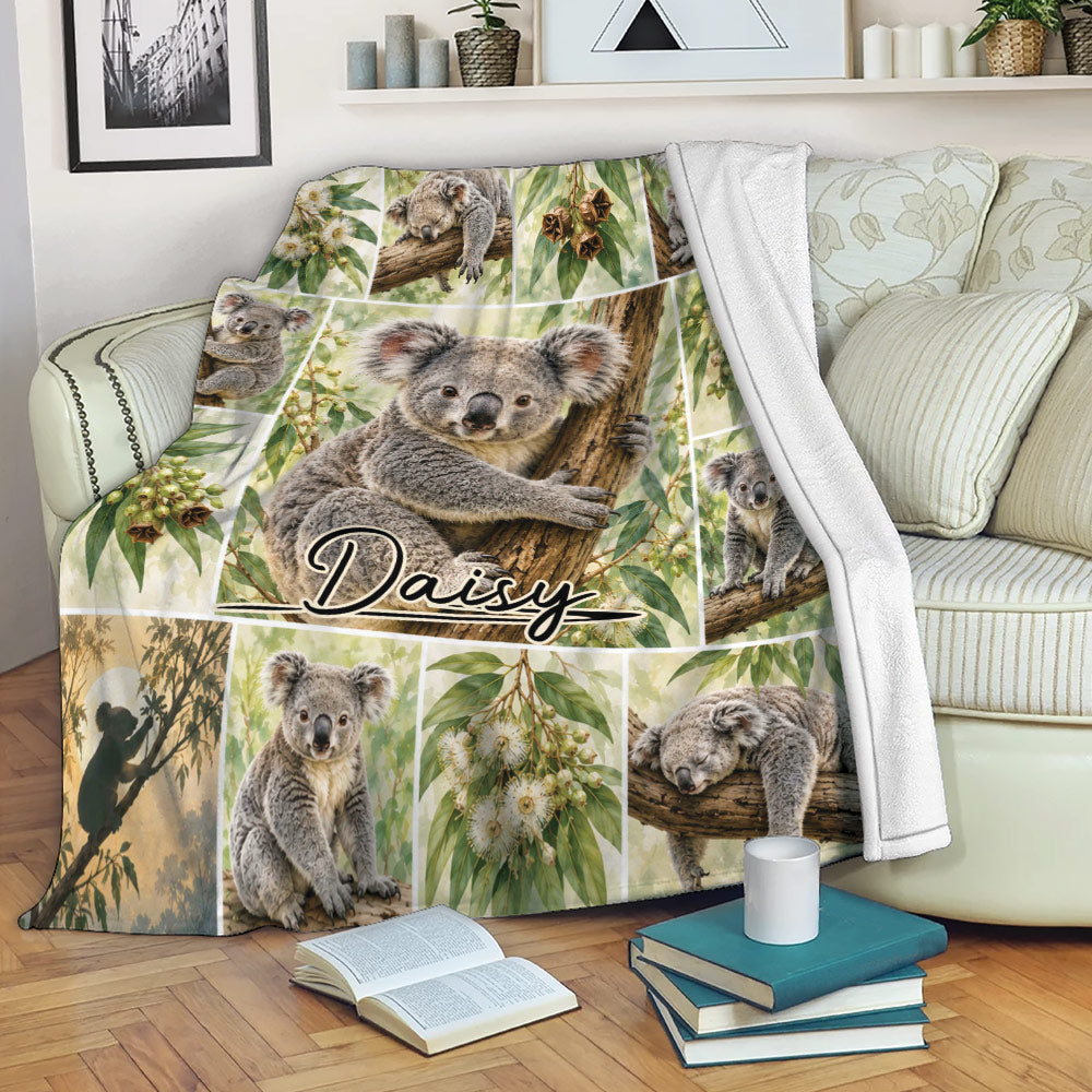 Koala throw blanket draped over a sofa with eucalyptus artwork and cozy reading room decor