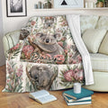 Koala throw blanket draped over a couch with Australian floral artwork and cozy reading nook styling