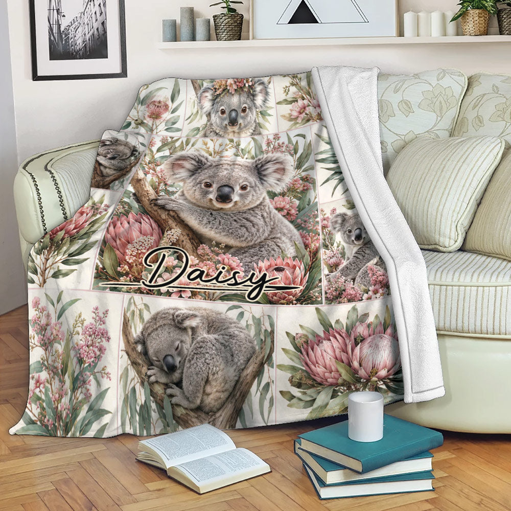 Koala throw blanket draped over a couch with Australian floral artwork and cozy reading nook styling