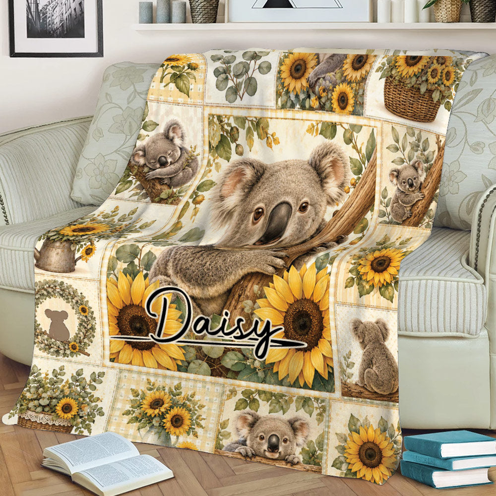Close view of a koala throw blanket with sunflowers on a sofa
