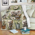 Koala floral throw blanket displayed on a sofa with repeating koala illustrations, daisies, and soft green accents