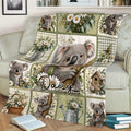 Close lifestyle view of a koala throw blanket with floral patchwork artwork draped across a sofa