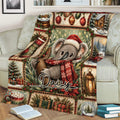 Close lifestyle view of a Christmas koala throw blanket with ornaments, gifts, greenery, and cozy holiday artwork