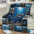 Ocean shark throw blanket arranged on a couch with underwater scenery, nautical symbols, coral, and sea life