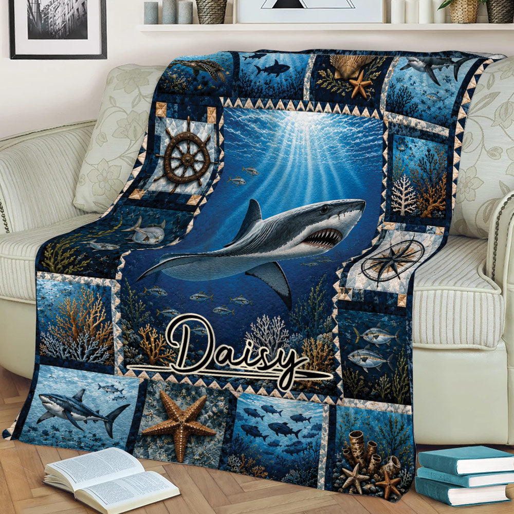 Ocean shark throw blanket arranged on a couch with underwater scenery, nautical symbols, coral, and sea life