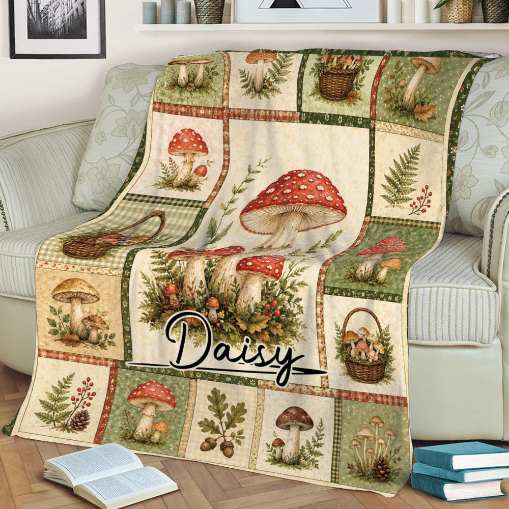 Vintage botanical mushroom blanket styled on a sofa with illustrated fungi, baskets, ferns, leaves, and berries