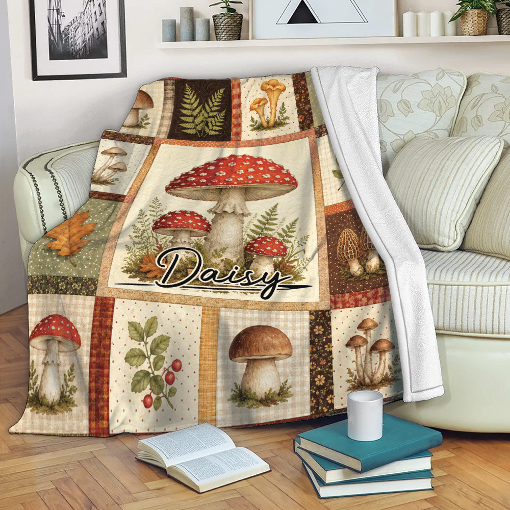 Mushroom throw blanket draped over a sofa with vintage fungi, fern, leaf, and woodland artwork