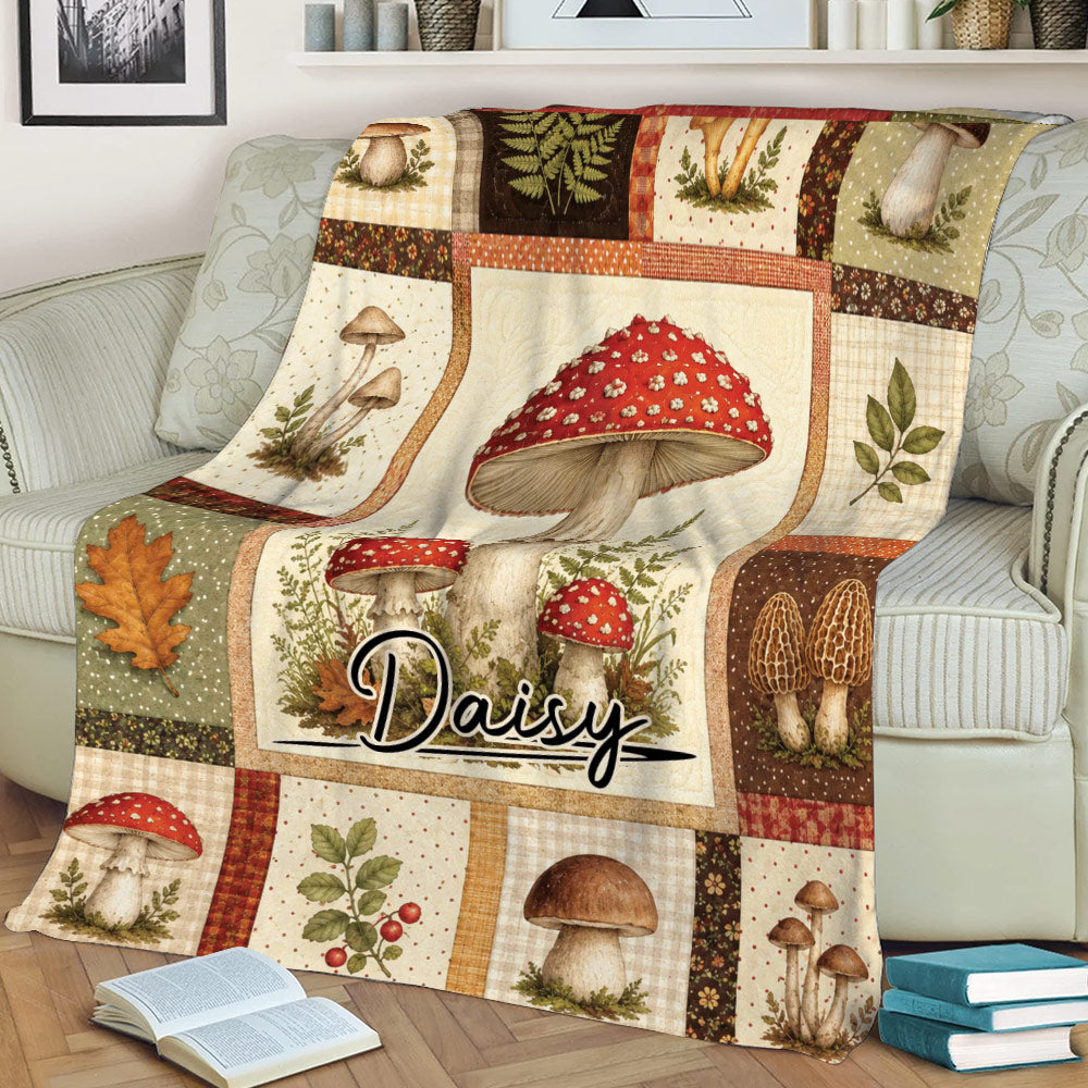 Mushroom blanket styled on a sofa with illustrated red-capped mushrooms and rustic botanical panels
