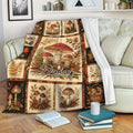 Mushroom blanket draped over a sofa, featuring a vintage autumn woodland design with fungi and botanical panels