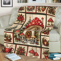 Mushroom blanket displayed on a couch with a large red spotted mushroom and vintage Christmas woodland design