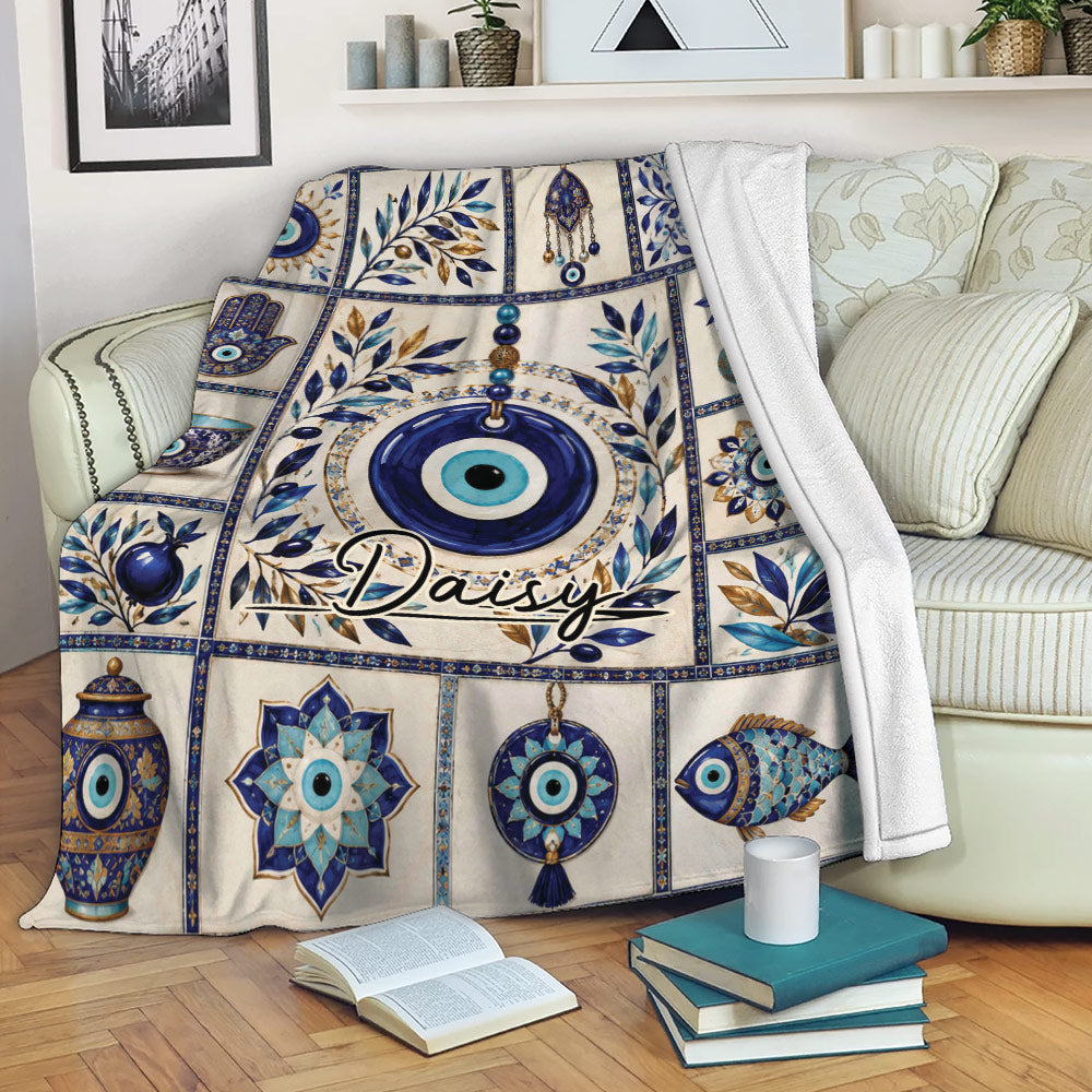 Blue Evil Eye throw blanket displayed on a sofa with Nazar symbols, leafy artwork, and ornate medallions