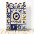 Evil Eye throw blanket displayed upright with blue nazar symbols, floral motifs, moon imagery, and decorative panels