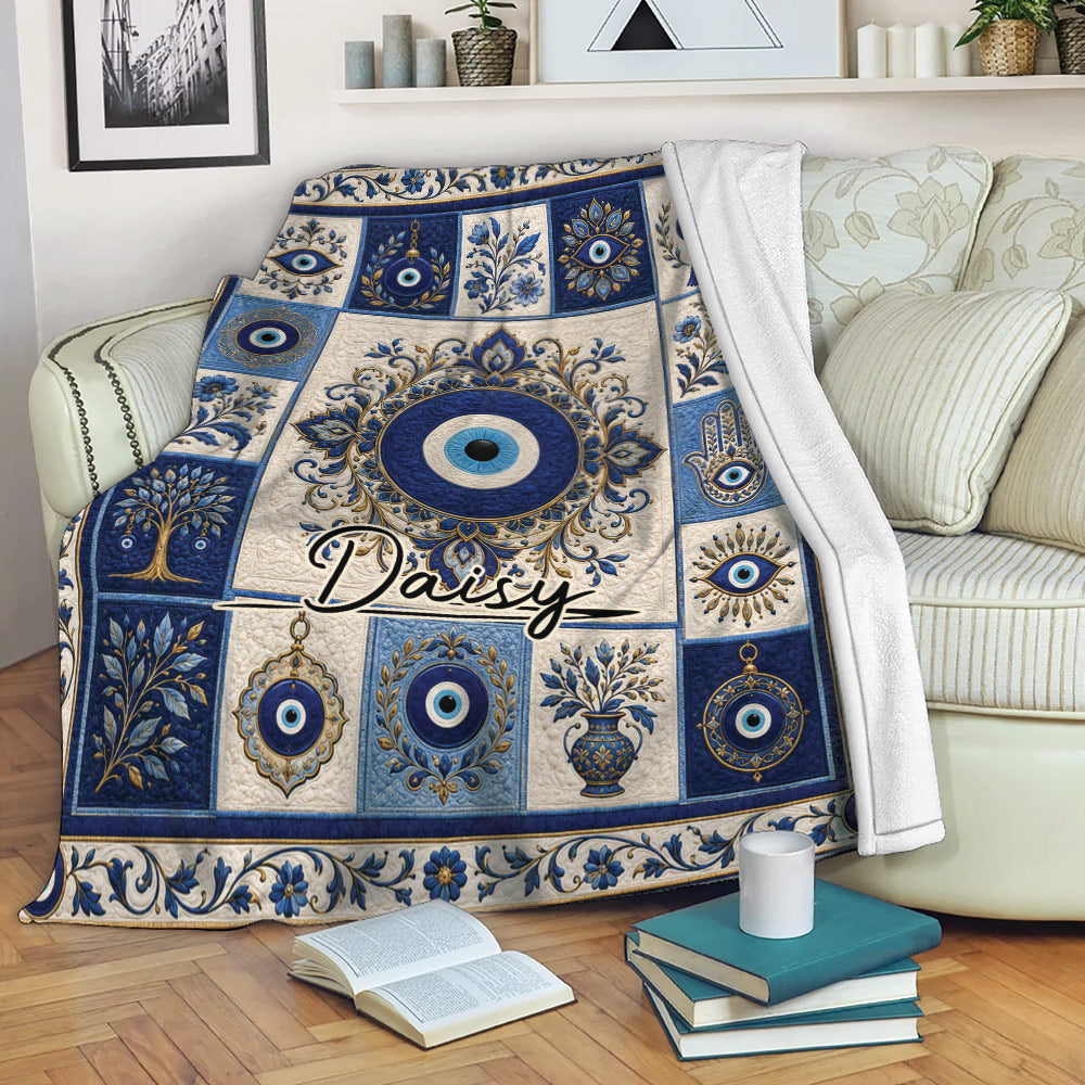 Evil eye throw blanket styled over a sofa with blue ornamental artwork and floral details