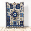 Blue and cream evil eye blanket with ornate floral panels and repeating protective eye motifs