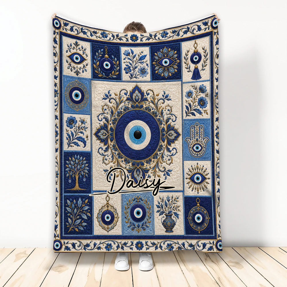 Blue and cream evil eye blanket with ornate floral panels and repeating protective eye motifs