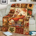 Fall harvest throw blanket displayed on a sofa with pumpkins, leaves and autumn landscape panels