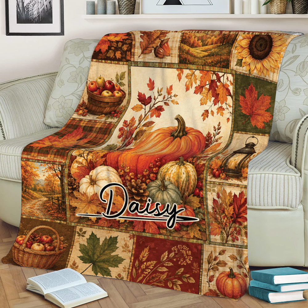 Fall harvest throw blanket displayed on a sofa with pumpkins, leaves and autumn landscape panels
