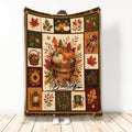 Autumn harvest blanket with pumpkins, fall leaves, acorns, apples, and warm rustic colors