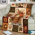Fall pumpkin and leaf throw blanket displayed across a sofa in a cozy living room