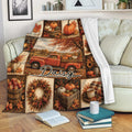 Autumn harvest blanket draped over a sofa with pumpkins, leaves, flowers, and a rustic truck scene
