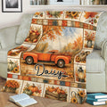 Cozy autumn blanket displayed on a sofa with pumpkin harvest, orange truck, sunflowers, and rustic fall artwork