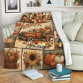 Thanksgiving throw blanket draped over a sofa with pumpkins, harvest scenes, autumn leaves, and sunflower artwork