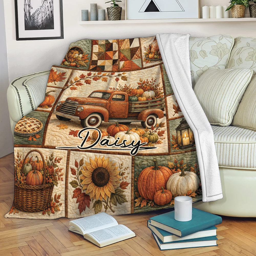 Thanksgiving throw blanket draped over a sofa with pumpkins, harvest scenes, autumn leaves, and sunflower artwork