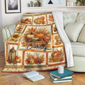 Thanksgiving harvest blanket displayed on a sofa with pumpkins, autumn leaves, pie, and cozy seasonal artwork