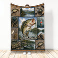 Fishing blanket with lake scenes, fishing gear, boat and large fish artwork in a rustic collage design