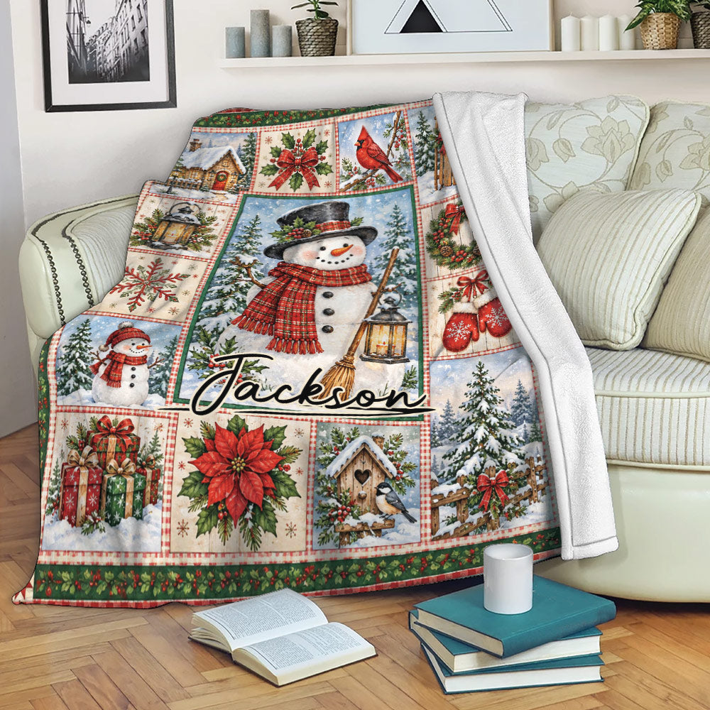 Christmas throw blanket draped over a sofa with snowman artwork, winter scenes, wreaths, mittens, and gifts