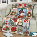 Snowman Christmas throw blanket displayed on a sofa with holiday patchwork scenes and festive winter decorations