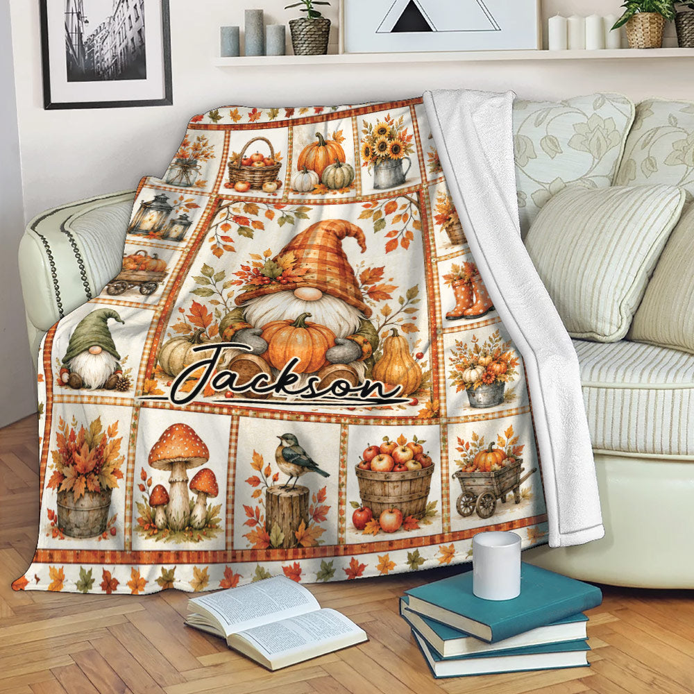 Autumn gnome throw blanket draped over a sofa with pumpkins, sunflowers and harvest accents