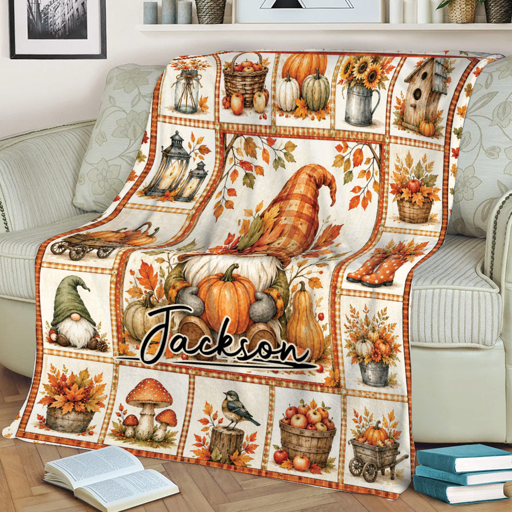 Rustic fall gnome blanket displayed on a couch with pumpkins, leaves, apples and harvest artwork