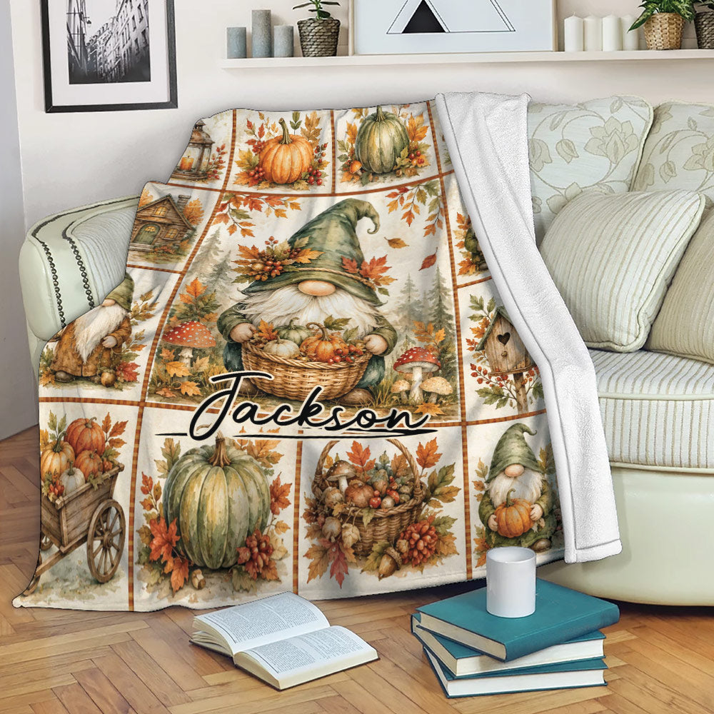 Rustic fall gnome throw blanket displayed on a sofa with pumpkins, mushrooms, and harvest artwork